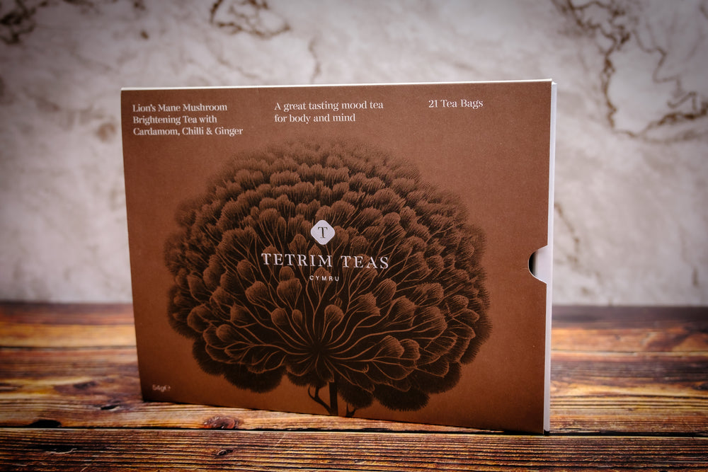 Packaging of Lion's Mane Mushroom Brightening Tea with Cardamom, Chilli & Ginger by Tetrim Teas, featuring a brown label with a floral design.