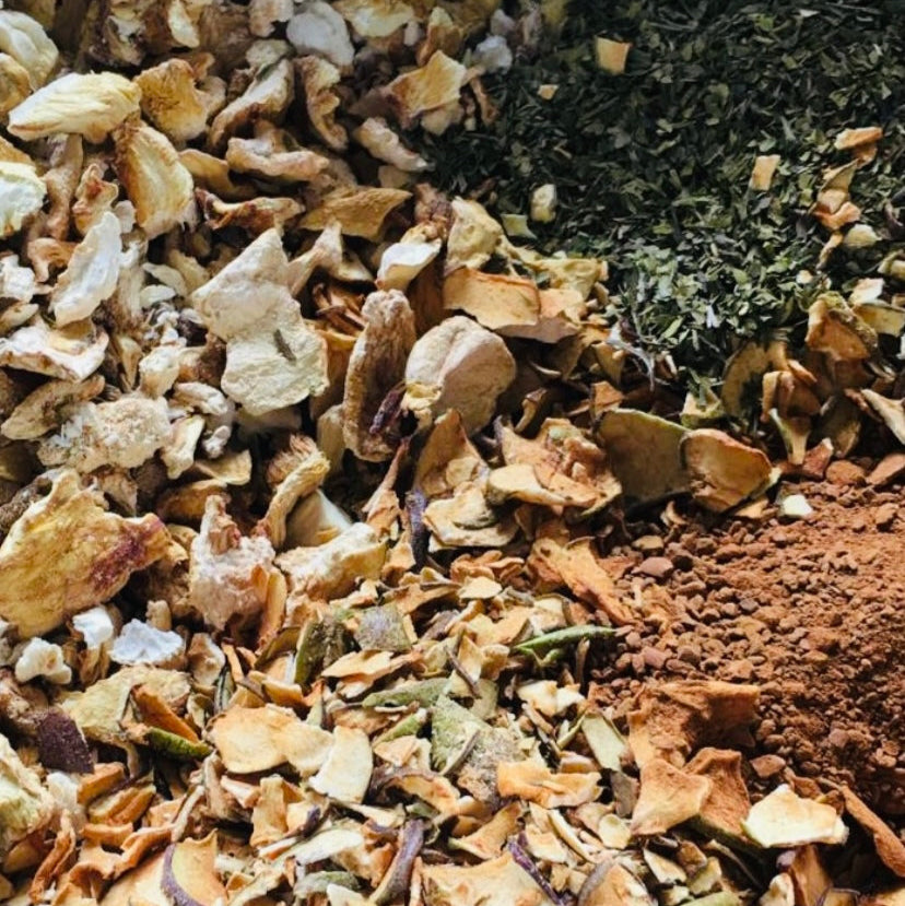 
                  
                    A close-up of dried lion's mane mushroom pieces, welsh heritage apples, and cinnamon sticks used for making the tea infusion.
                  
                